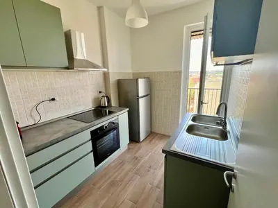a small kitchen with a sink and a refrigerator at Il Cielo Su Roma San Paolo in Rome