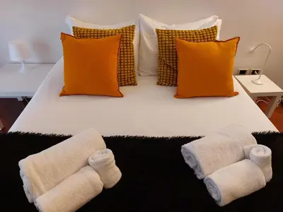 a bed with two towels on it with pillows at Monti Parioli de Charme in Rome