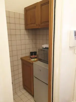 a small kitchen with a stove and a refrigerator at Monti Parioli de Charme in Rome