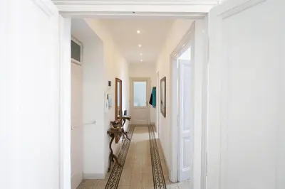 a hallway with white walls and a tile floor at Cherry Suites- Timeless Roman Residence & Terrace in Rome
