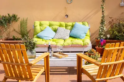 a yellow couch sitting on a patio with two chairs at Cherry Suites- Timeless Roman Residence & Terrace in Rome