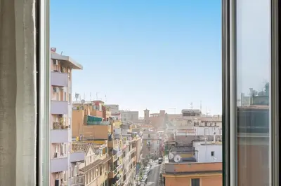 a view of a city from a window at Cherry Suites- Timeless Roman Residence & Terrace in Rome