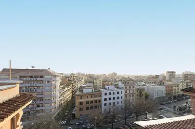 a view of a city with buildings and cars at Cherry Suites- Timeless Roman Residence & Terrace in Rome