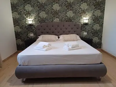 a bedroom with a bed with two towels on it at Mimmi's house in Rome