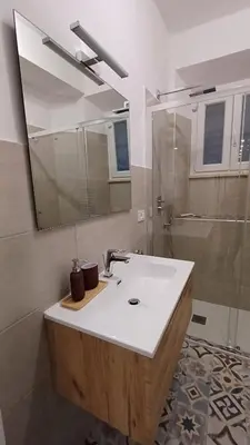a bathroom with a sink and a mirror and a shower at Mimmi's house in Rome