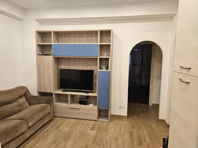 a living room with a couch and a flat screen tv at La Casa di Fede in Rome