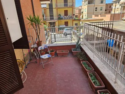 a balcony with potted plants and a fence at La Casa di Fede in Rome