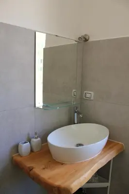 a bathroom with a white sink and a mirror at Epirhome, tra Colosseo e Porta Santa in Rome