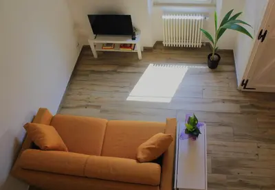 a living room with a couch and a television at Epirhome, tra Colosseo e Porta Santa in Rome