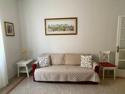 a living room with a couch and a picture on the wall at Casa vacanza Brandi in Rome