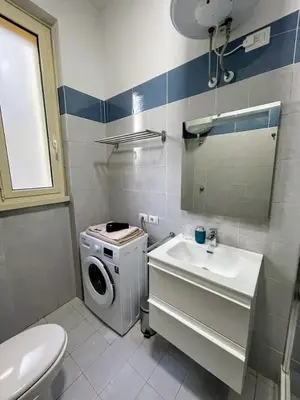 a bathroom with a washing machine and a sink at Casa vacanza Brandi in Rome