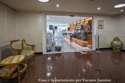 a room with a store with a chair and a window at Casa e Appartamento per Vacanze JASMINE in Rome