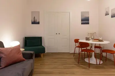 a living room with a couch and a table and chairs at DaliTourism - La Casa di Pida Vatican Apartment in Rome