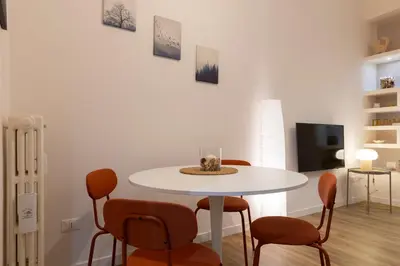 a white dining room with a white table and chairs at DaliTourism - La Casa di Pida Vatican Apartment in Rome