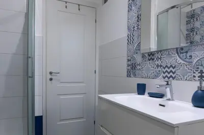 a white bathroom with a sink and a mirror at DaliTourism - La Casa di Pida Vatican Apartment in Rome