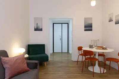 a living room with a couch and a table and chairs at DaliTourism - La Casa di Pida Vatican Apartment in Rome