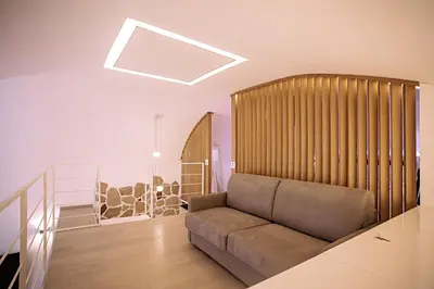 a living room with a couch in the middle of a room at Pantheon Luxury Apartment in Rome