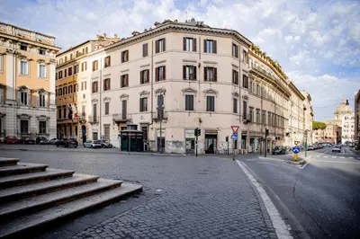 a large white building on a city street at Pantheon Luxury Apartment in Rome