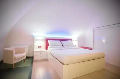 a bedroom with a large bed and a chair at Pantheon Luxury Apartment in Rome
