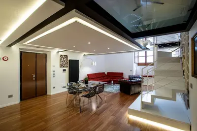 a living room with a glass table and a red couch at Pantheon Luxury Apartment in Rome
