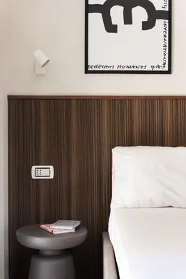 a bedroom with a bed and a stool with a sign on it at Vatican Loft - San Pietro in Rome