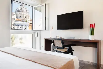 a bedroom with a desk with a computer and a window at Vatican Loft - San Pietro in Rome