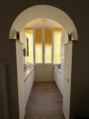 an archway leading into a kitchen with a window at La Casa di Léon - Battistini - Vaticano in Rome