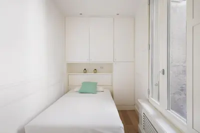 a white room with a bed and a window at Crystal Home Piazza Navona in Rome
