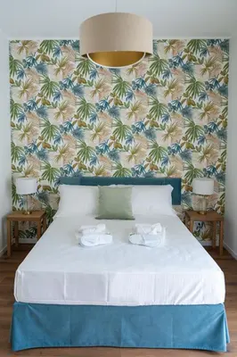 a bedroom with a bed with two white shoes on it at Appartamento con 2 camere e 2 bagni -San Giovanni- in Rome