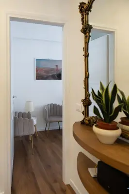 a mirror sitting on a table in a room at Appartamento con 2 camere e 2 bagni -San Giovanni- in Rome