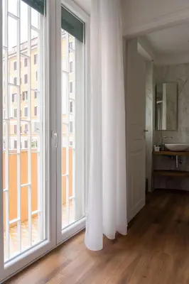 a white room with a large window and a sink at Appartamento con 2 camere e 2 bagni -San Giovanni- in Rome