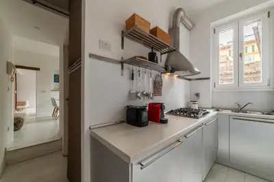 a kitchen with white walls and a counter top at GuestHost - Piazza de' Renzi Duplex Apartment in Rome