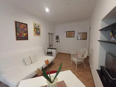 a living room with a white couch and a tv at Famy in Rome
