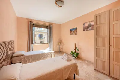 a bedroom with two beds and a window at Apartment27 Roma in Rome