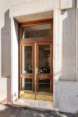 a wooden door on the side of a building at Apartment27 Roma in Rome