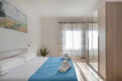 a bedroom with a bed with towels on the floor at Apartment27 Roma in Rome