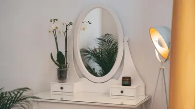 a mirror on top of a white shelf with plants at TIBERIM Exclusive Rome in Rome