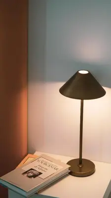a lamp sitting on a table next to a book at TIBERIM Exclusive Rome in Rome