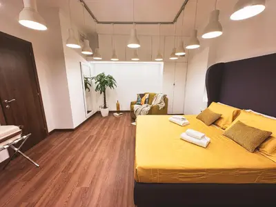 a bedroom with a yellow bed and a living room at TIBERIM Exclusive Rome in Rome