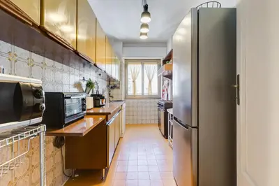 a kitchen with a stainless steel refrigerator at The Pope's Oasis near Trastevere and Historical Center in Rome