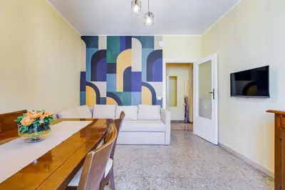 a living room with a white couch and a table at The Pope's Oasis near Trastevere and Historical Center in Rome