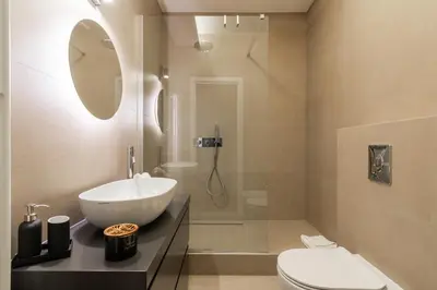 a bathroom with a sink and a toilet at Elegant Haven Re di Roma by Hostand in Rome