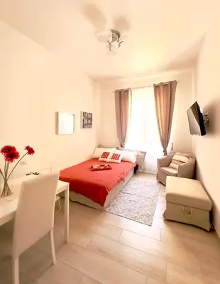 a bedroom with a bed and a table and a desk at Olimpia Bis - Gianicolo - Trastevere - Vaticano - Centro Storico di Roma in Rome