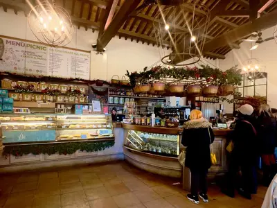a group of people standing at a counter in a store at Olimpia Bis - Gianicolo - Trastevere - Vaticano - Centro Storico di Roma in Rome
