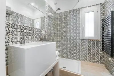 a white bathroom with a sink and a tub at Flaminio Garden, Indenpent Flat 10 min from the City Center in Rome