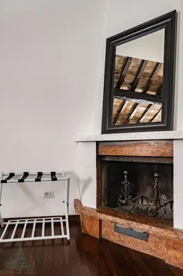 a fireplace with a mirror on top of it at Domus in Lauro in Rome