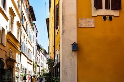 a street with buildings and people walking down the street at Domus in Lauro in Rome