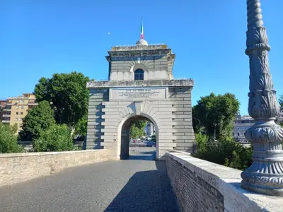a stone arch bridge with a street light at Home Rome in Rome