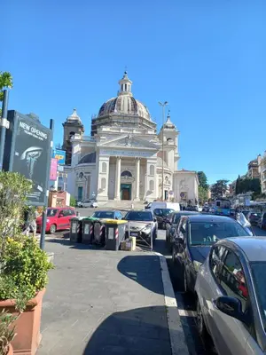 a building with a lot of cars parked in front of it at Home Rome in Rome