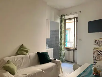 a living room with a white couch and a window at Home Rome in Rome